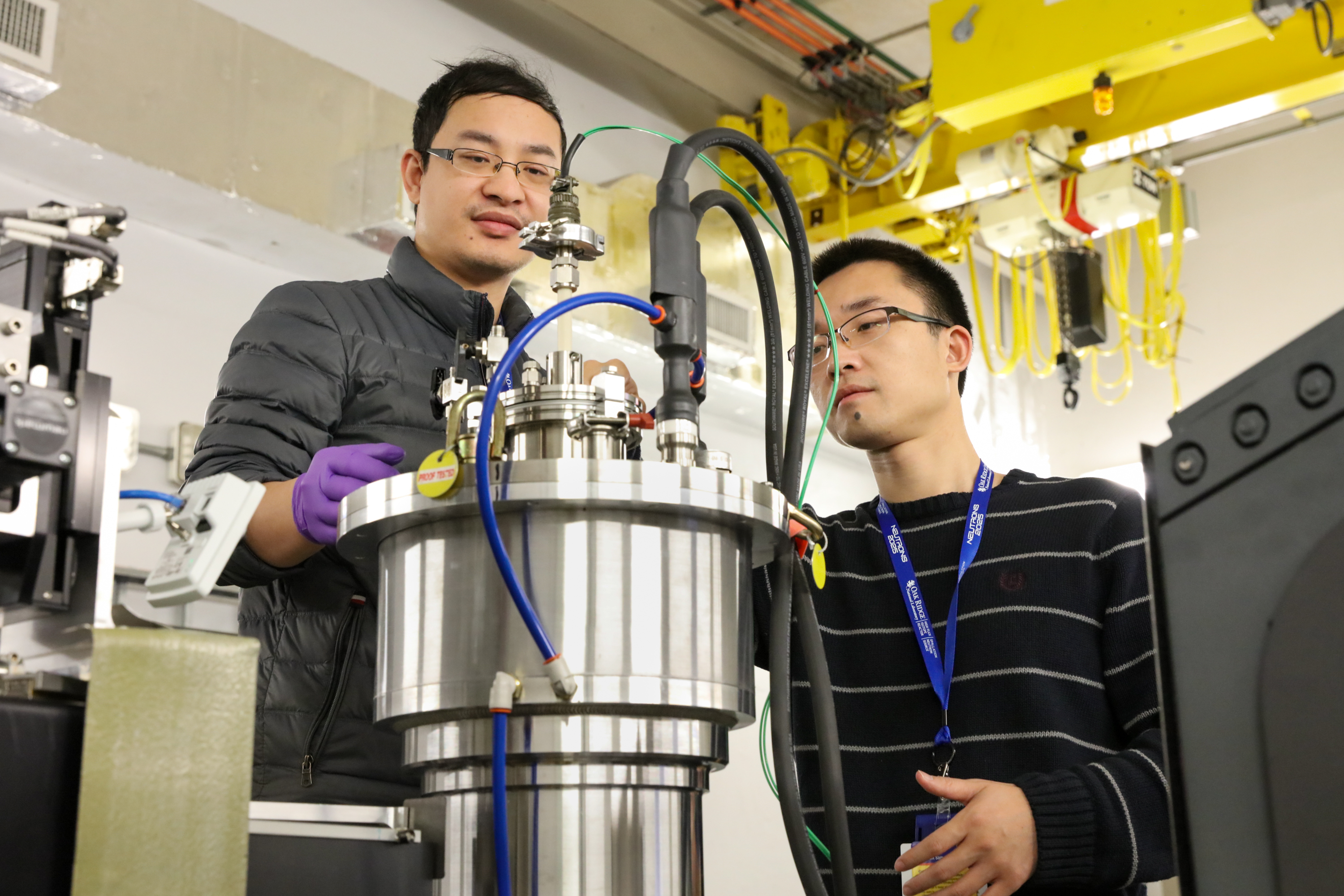 WVU researchers make adjustments to the furnace used to study high-entropy oxides under a range of temperatures from room temperature to 1,200° (2,192°F), allowing them to better understand how HEOs form during the manufacturing process. Photographed in December, 2019. (Credit: ORNL/Genevieve Martin)